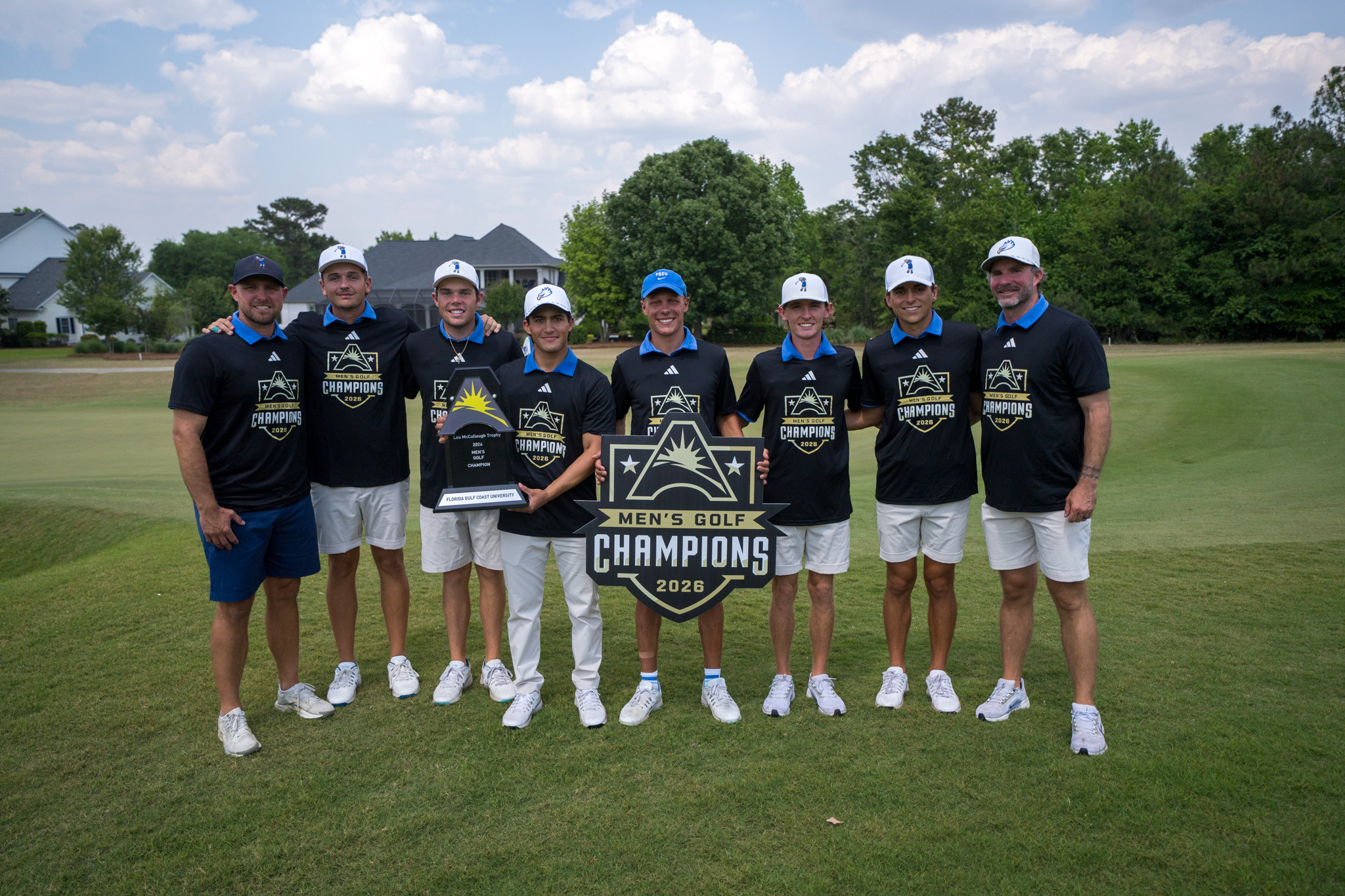FGCU men's golf team celebrates its first ASUN Championship victory with the trophy.